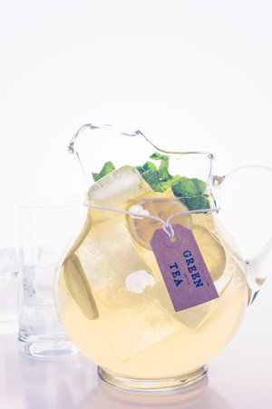 Green tea with citrus on a white backgound.