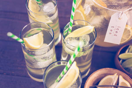 Green tea with citrus in glasses with ice and paper straw.の写真素材