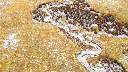 Aerial view of small mountain creek  in the Winter.