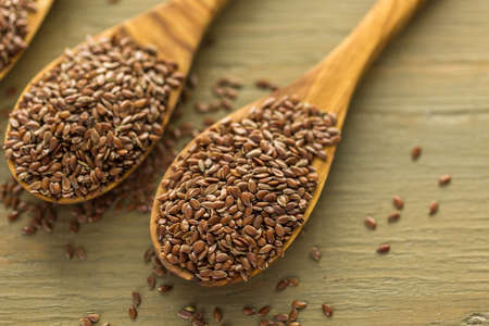 Flax seeds on painted wood board.の写真素材