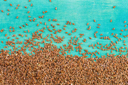 Flax seeds on painted wood board.の写真素材