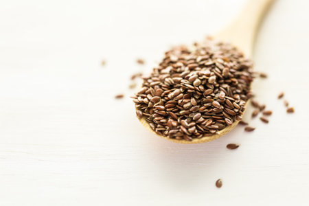 Flax seeds on painted wood board.の写真素材