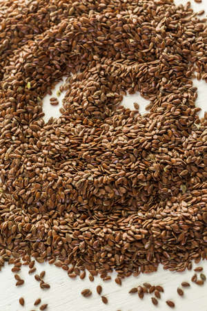 Flax seeds on painted wood board.の写真素材