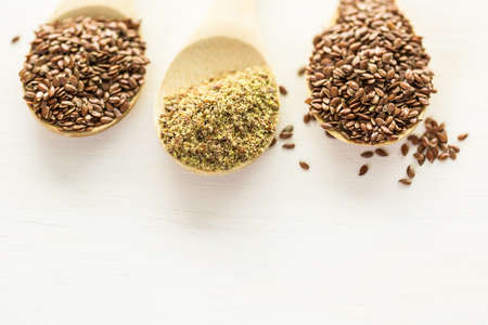 Flax seeds on painted wood board.の写真素材