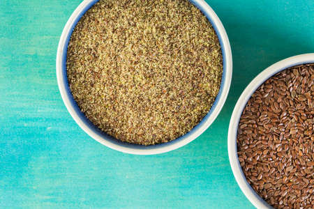 Flax seeds on painted wood board.の写真素材