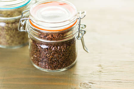 Flax seeds on painted wood board.の写真素材