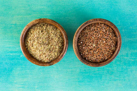 Flax seeds on painted wood board.の写真素材