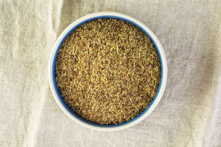 Flax seeds on painted wood board.の写真素材