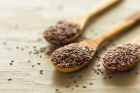 Flax seeds on painted wood board.の写真素材