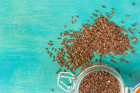 Flax seeds on painted wood board.