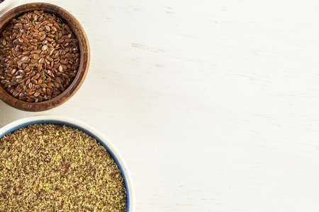 Flax seeds on painted wood board.の写真素材