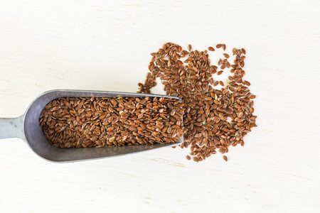 Flax seeds on painted wood board.の写真素材