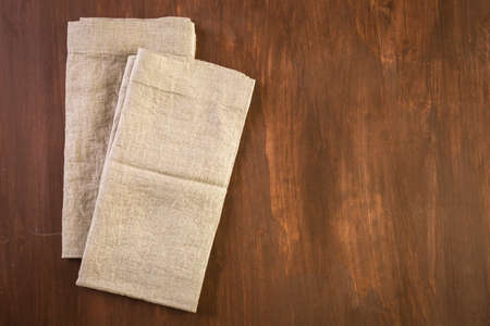 Linen dinner napkins on a wood background.の写真素材
