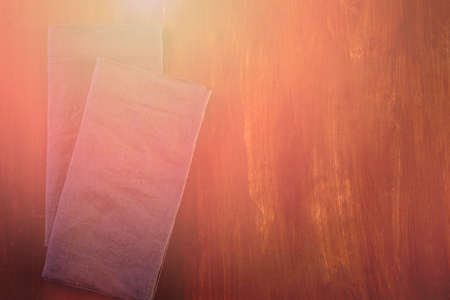 Linen dinner napkins on a wood background.の写真素材