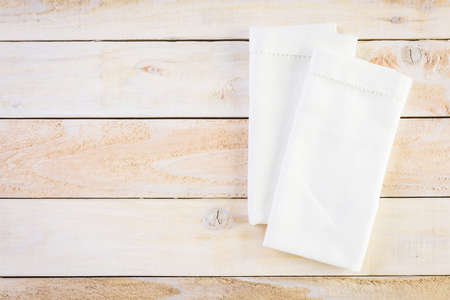 Linen dinner napkins on a wood background.の写真素材