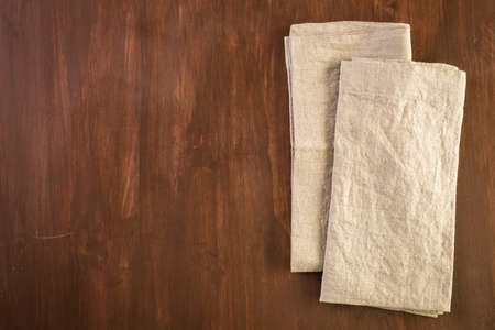Linen dinner napkins on a wood background.の写真素材