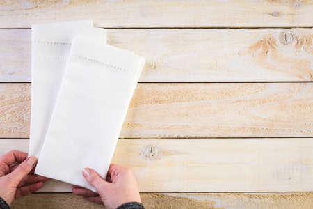Linen dinner napkins on a wood background.の写真素材