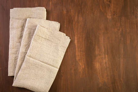 Linen dinner napkins on a wood background.の写真素材