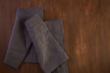 Linen dinner napkins on a wood background.の写真素材