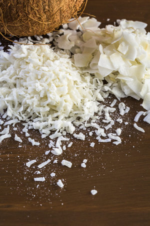 Dehydrated coconut flakes on a wood background.の写真素材