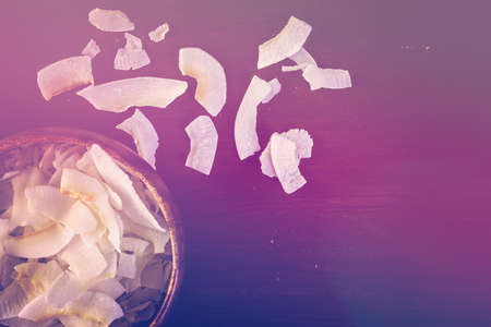 Dehydrated coconut flakes in wooden bowl.の写真素材