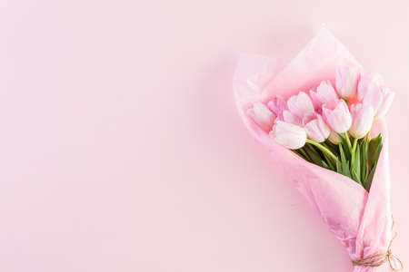 Bouquet of pink tulips wrapped in pink paper.の写真素材