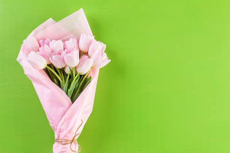 Bouquet of pink tulips on a green background.の写真素材