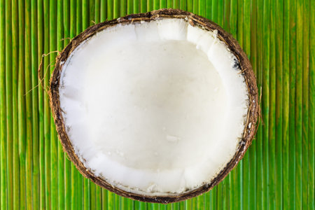 fresh opened coconut on a green background.