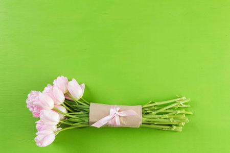 Bouquet of pink tulips on a green background.