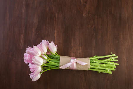 Bouquet of pink tulips on a wood background.の写真素材