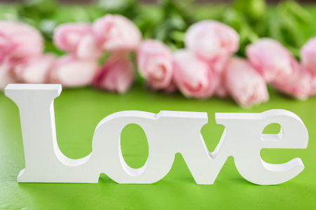 Light pink tulips on a green background.の写真素材