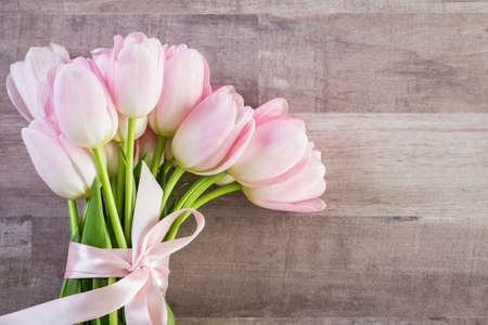 Bouquet of pink tulips on a wood background.の写真素材