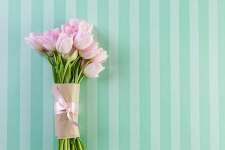 bouquet of pink tulips on a stripe blue background.の写真素材