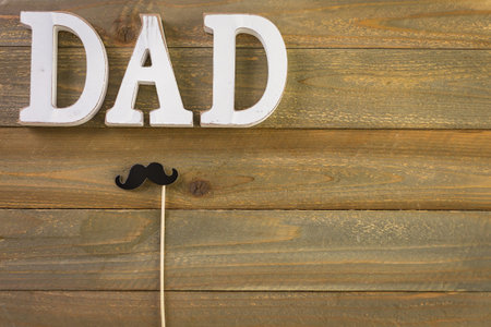 White letters DAD on a painted wood background.の写真素材