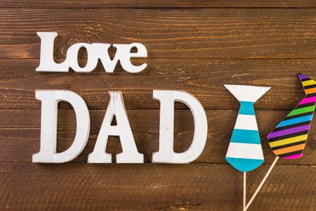 White letters DAD on a painted wood background.の写真素材