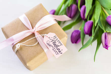 Small gift and purple tulips for Mother's Day.の写真素材