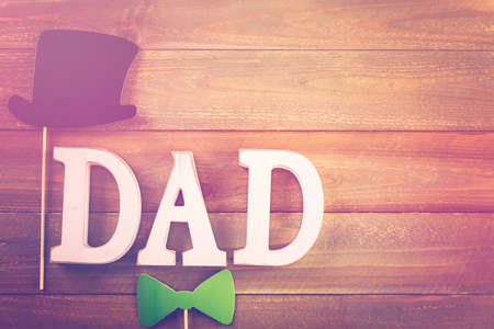 White letters DAD on a painted wood background.の写真素材