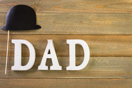 White letters DAD on a painted wood background.の写真素材
