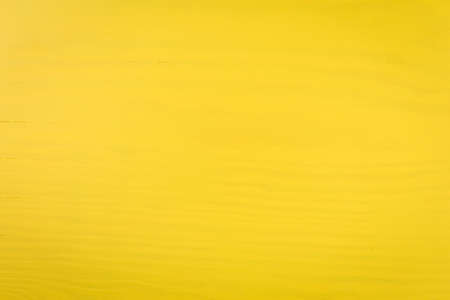 Board painted with bright yellow paint.の写真素材