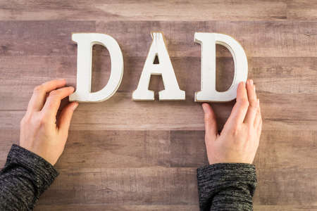 White letters DAD on a wood background.の写真素材