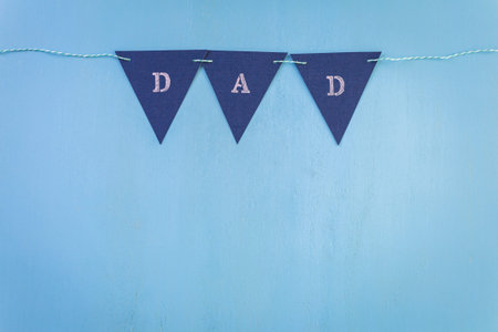 White letters DAD on a painted wood background.の写真素材
