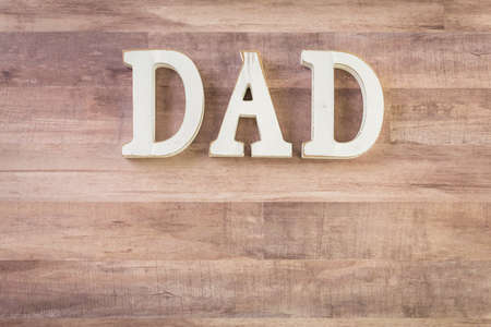 White letters DAD on a wood background.の写真素材