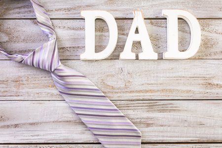 White letters DAD on a painted wood background.の写真素材