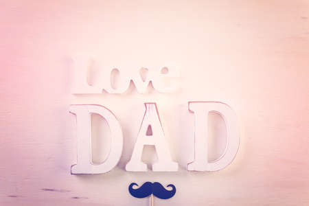White letters DAD on a painted wood background.の写真素材