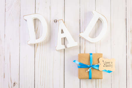 White letters DAD on a wood background.の写真素材