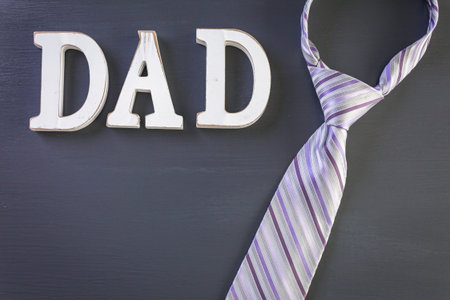 White letters DAD on a painted wood background.の写真素材