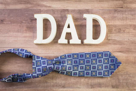 White letters DAD on a wood background.の写真素材