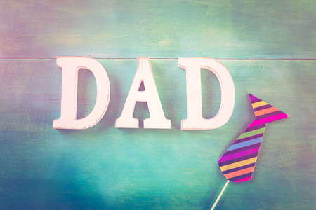 White letters DAD on a painted wood background.の写真素材