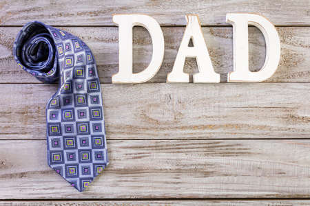White letters DAD on a painted wood background.の写真素材