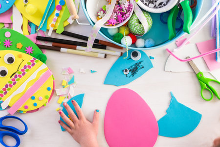 Step by step. Mother and daughter decorating paper Easter eggs.